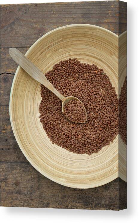 Spoon Canvas Print featuring the photograph Bowl Of Lentils With Wooden Spoon On by Westend61