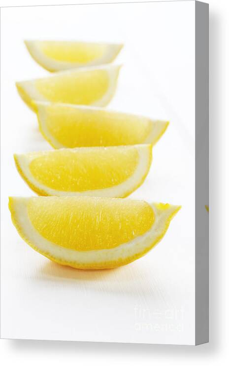 Lemon Canvas Print featuring the photograph Lemon Wedges on White Background by Colin and Linda McKie