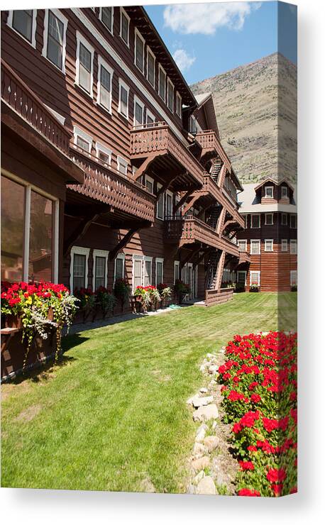 Glacier Canvas Print featuring the photograph Many Glacier Hotel With Flowers by Bruce Gourley