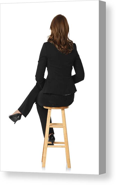 Stiletto Canvas Print featuring the photograph Rear view of a businesswoman sitting on stool by 4x6