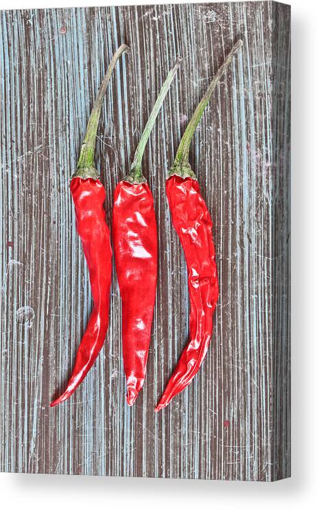 Background Canvas Print featuring the photograph Red chilis by Tom Gowanlock