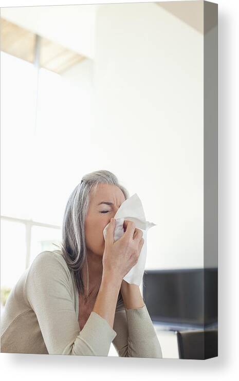 Cold And Flu Canvas Print featuring the photograph Sick woman blowing her nose by Sam Edwards