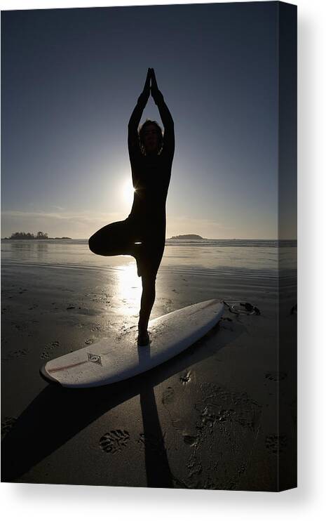 Day Canvas Print featuring the photograph Silhouette Of Female Surfer Doing Yoga by Deddeda