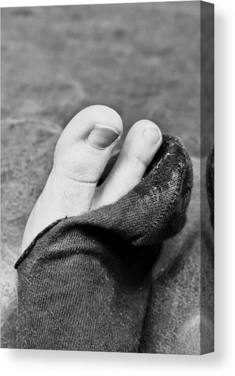 Black Canvas Print featuring the photograph Torn sock by Tom Gowanlock