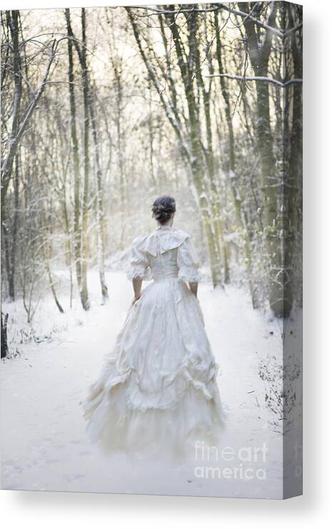 Woman Canvas Print featuring the photograph Victorian Woman Running Through A Winter Woodland With Fallen Sn by Lee Avison
