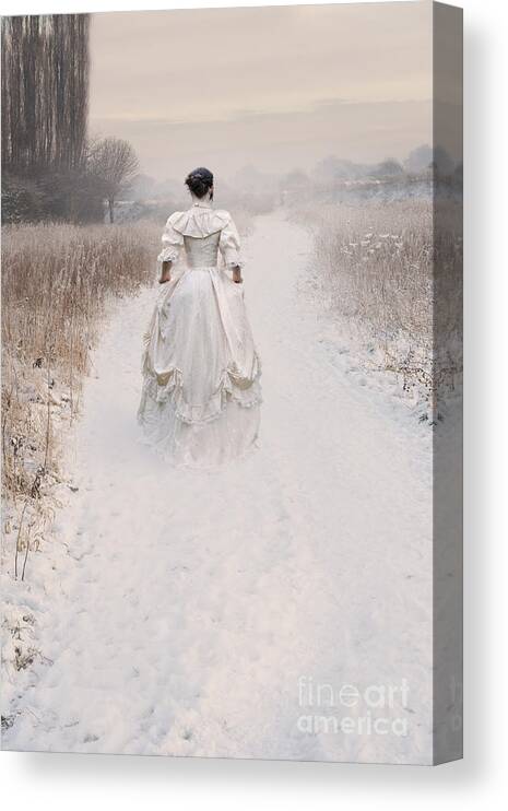 Woman Canvas Print featuring the photograph Victorian Woman Walking Through A Winter Meadow by Lee Avison
