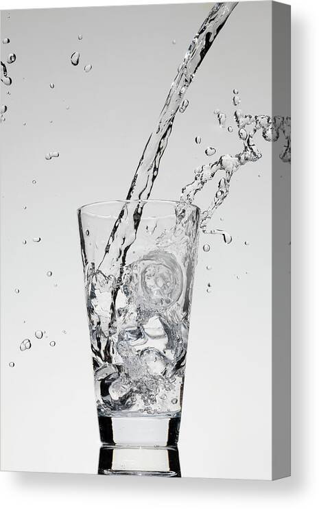 Mid-air Canvas Print featuring the photograph Water Being Poured Into A Glass by Dual Dual