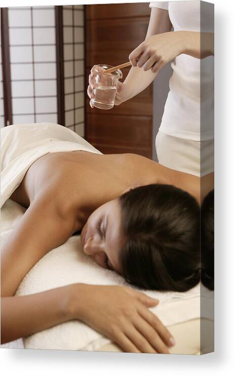 Relief Canvas Print featuring the photograph Woman getting hot oil massage by Comstock Images