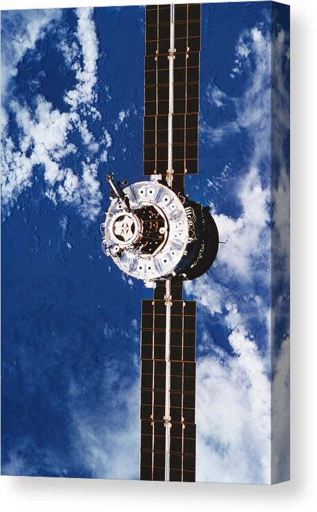 Vertical Canvas Print featuring the photograph A Satellite Orbiting Above The Earth #3 by Stockbyte