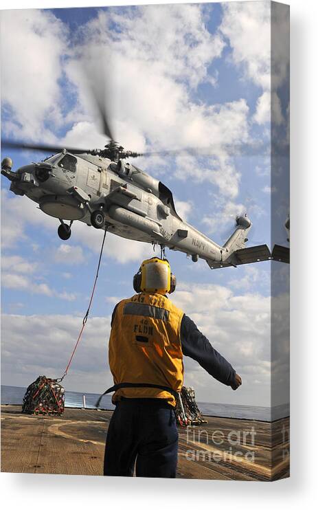 Uss Anzio Canvas Print featuring the photograph An Sh-60b Sea Hawk Helicopter Releases by Stocktrek Images