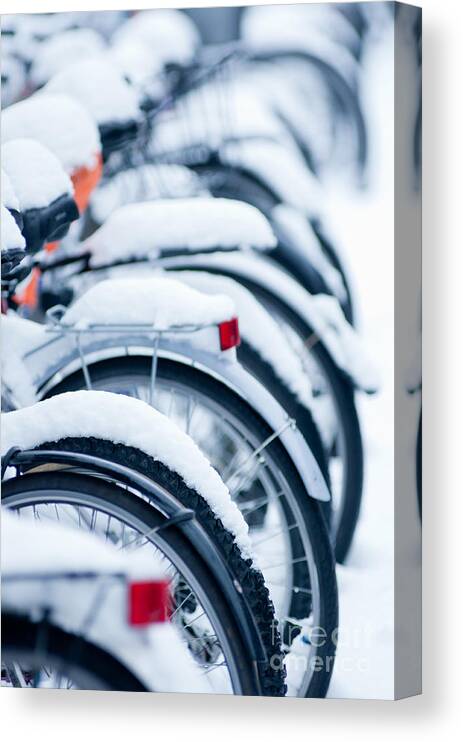 Abstract Canvas Print featuring the photograph Bikes in snow by Andrew Michael