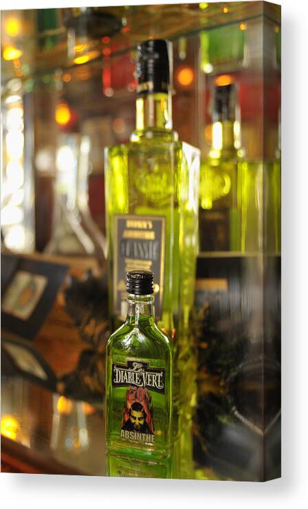 Absinthe Canvas Print featuring the photograph Bottles with Absinthe in Bar by Matthias Hauser