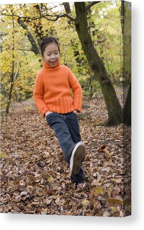 Human Canvas Print featuring the photograph Girl Kicking Leaves by Ian Boddy