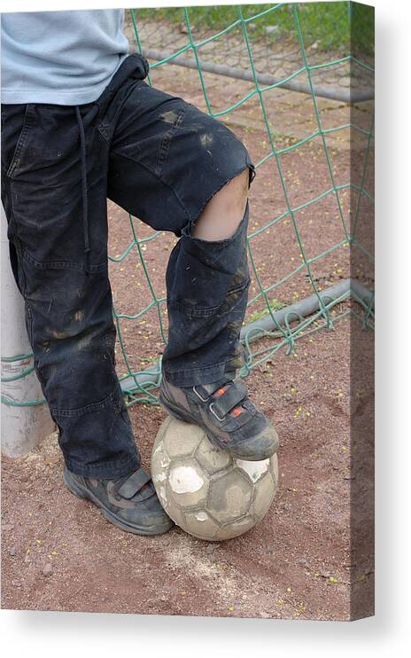 Ball Canvas Print featuring the photograph Street soccer - torn trousers and ball by Matthias Hauser