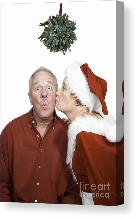 Man Canvas Print featuring the photograph Kissed under the mistletoe by Karen Foley