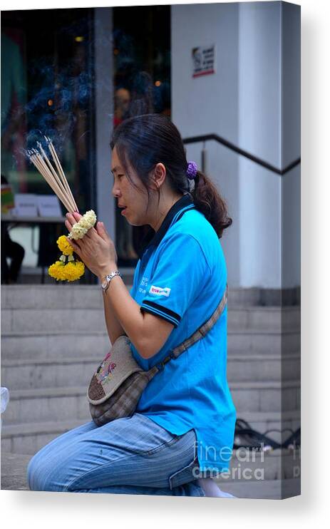 Woman Canvas Print featuring the photograph Thai woman worships and prays at outdoor shrine altar Bangkok Thailand by Imran Ahmed