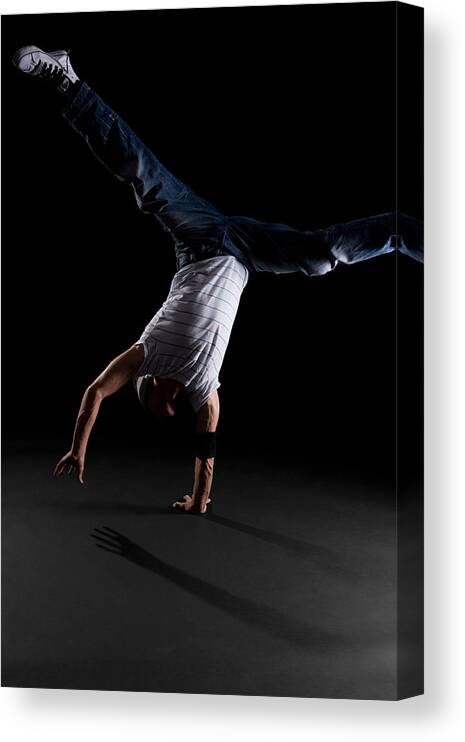 Expertise Canvas Print featuring the photograph A B-boy Doing A One-handed Freeze by Halfdark