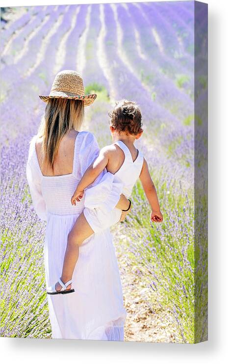 Adults Canvas Print featuring the photograph Back View Of Mother Holding Her Little Son In Front Of Lavender Field by Cavan Images
