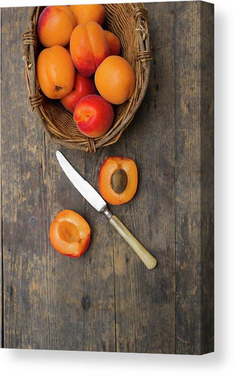 Apricot Canvas Print featuring the photograph Basket Of Apricots With Knife On Wooden by Westend61