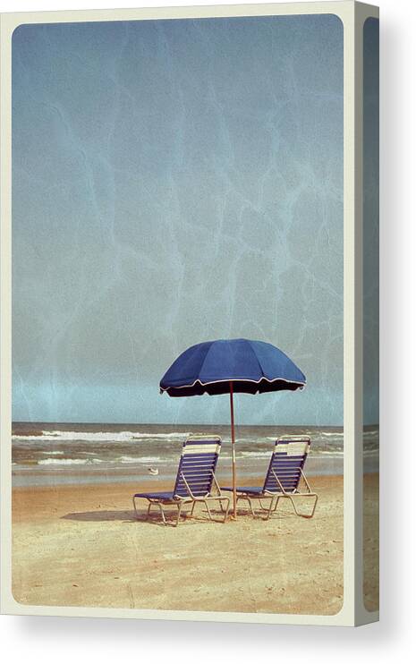Water's Edge Canvas Print featuring the photograph Beach Umbrella And Chairs - Vintage by Jitalia17