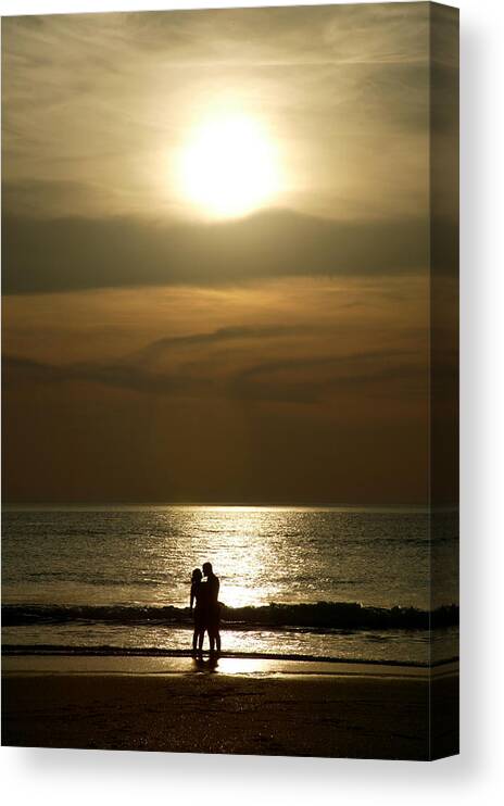 Concepts & Topics Canvas Print featuring the photograph Couple At Sunset On Beach by Jezphotos