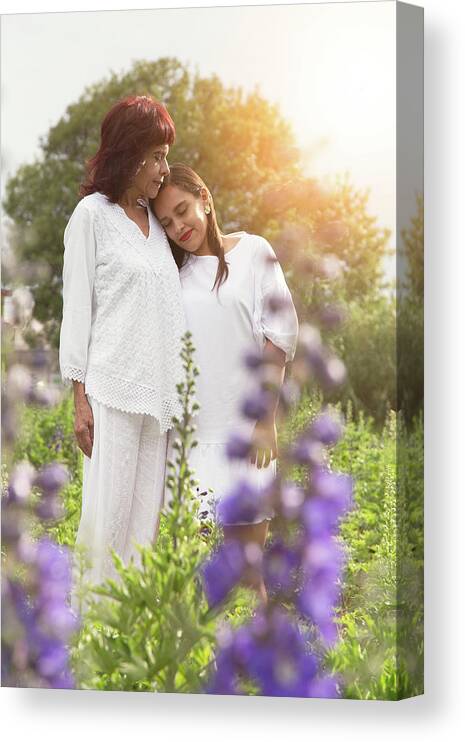 Love Canvas Print featuring the photograph Hispanic Mother Hugging Her Daughter At Flower Field During Sunset by Cavan Images