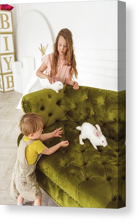 Adorable Canvas Print featuring the photograph Kids Playing With A Rabbit For Easter by Cavan Images