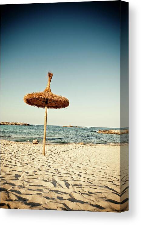 Water's Edge Canvas Print featuring the photograph Lonely Beach Umbrella by Ldf