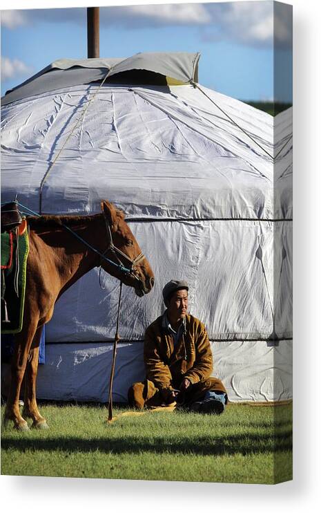 Horse Canvas Print featuring the photograph Mongolian Herder Sits Outside Ger With by Timothy Allen