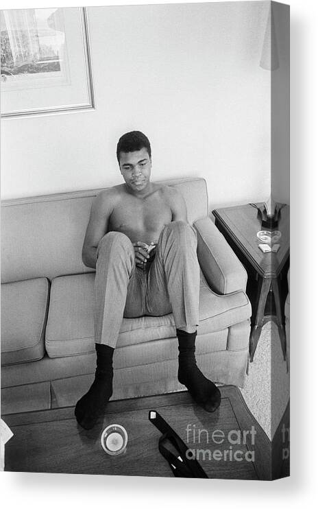 Following Canvas Print featuring the photograph Muhammad Ali Seated On Couch by Bettmann