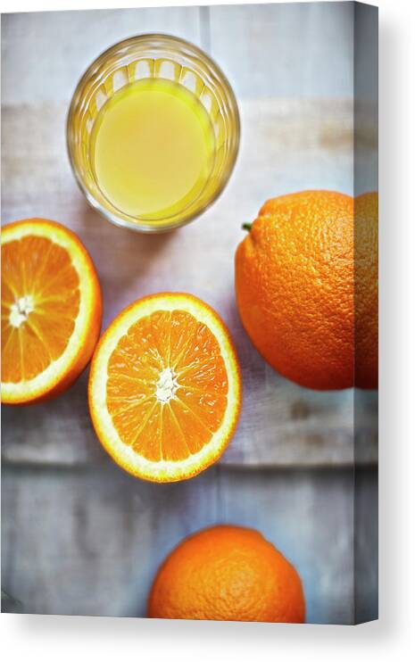 Orange Canvas Print featuring the photograph Oranges, Halves Of Oranges And A Glass by Westend61