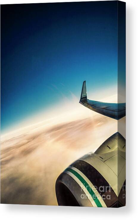 Amyn Nasser Canvas Print featuring the photograph Sleek Jet Blue Sky Aerial by Neptune - Amyn Nasser Photographer