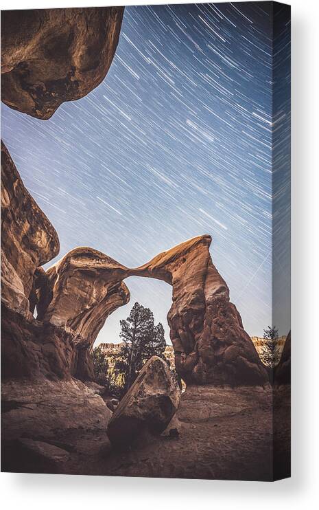 Devil's Garden Canvas Print featuring the photograph Star trails over Metate Arch by Mati Krimerman