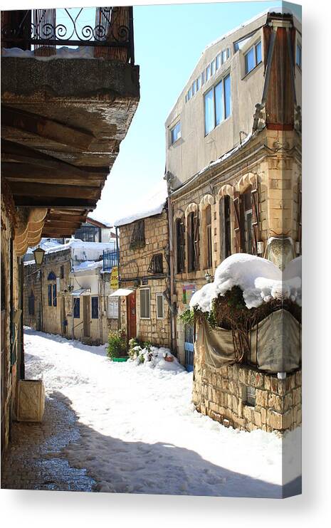  Canvas Print featuring the photograph The Old City of Safed in the Galilee in the snow by Alon Mandel