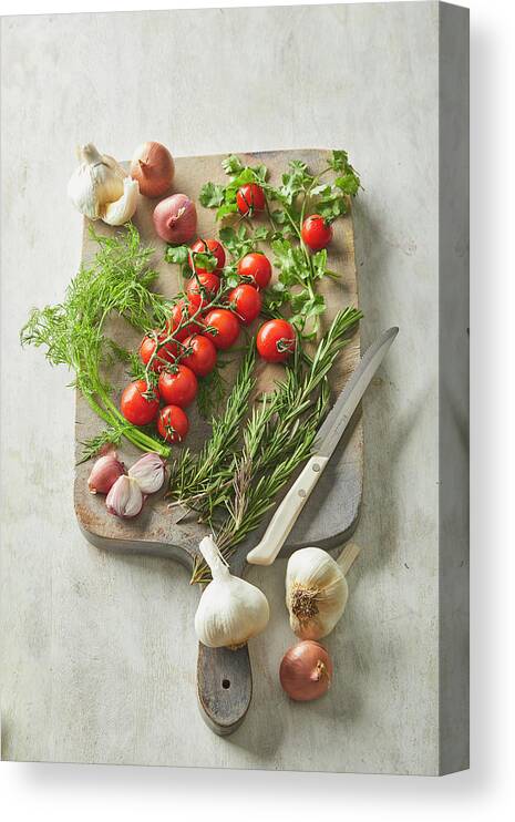 Cuisine At Home Canvas Print featuring the photograph Vegetables and herbs on a cutting board by Cuisine at Home