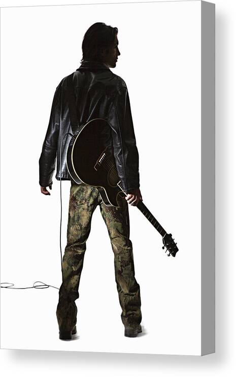 Young Men Canvas Print featuring the photograph Young Man Holding Guitar, Rear View by Emmanuel Faure