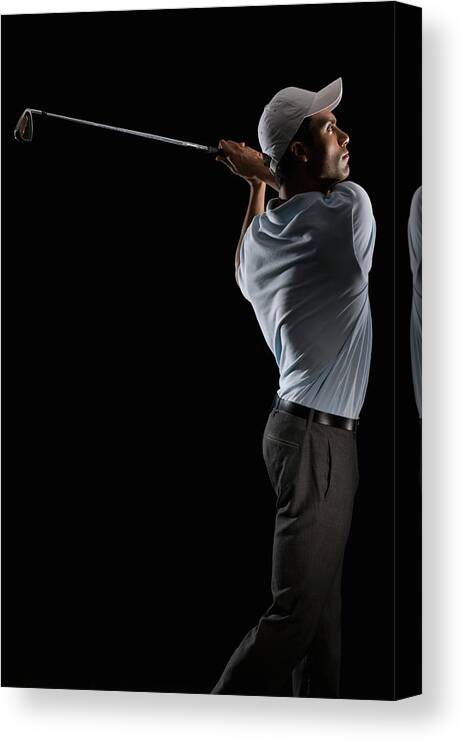 Human Arm Canvas Print featuring the photograph Young Man Swinging A Golf Club by Pm Images