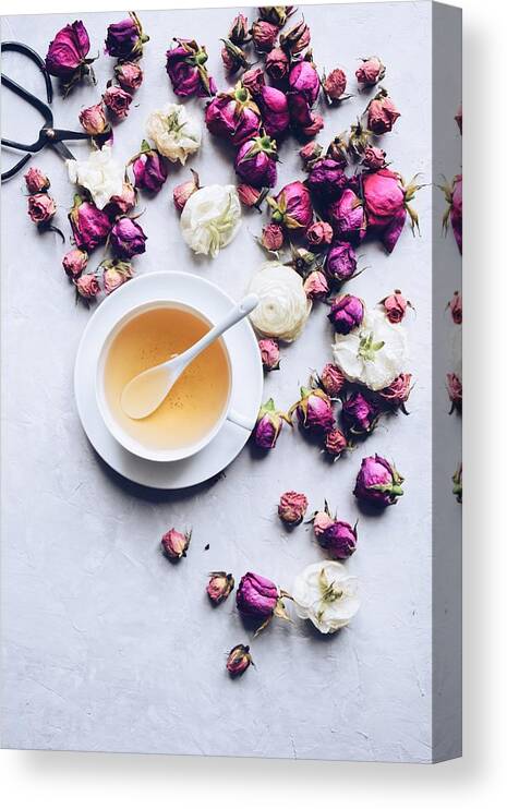 Fragility Canvas Print featuring the photograph Cup of herbal tea with dried roses #1 by JuliaK