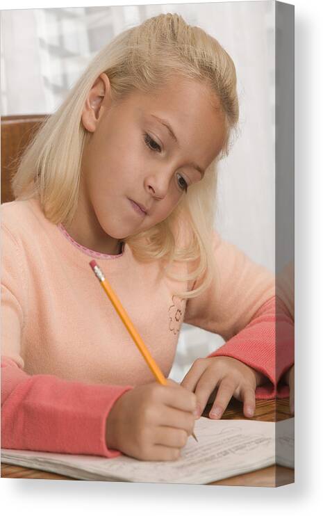 4-5 Years Canvas Print featuring the photograph Girl doing homework #1 by Comstock Images