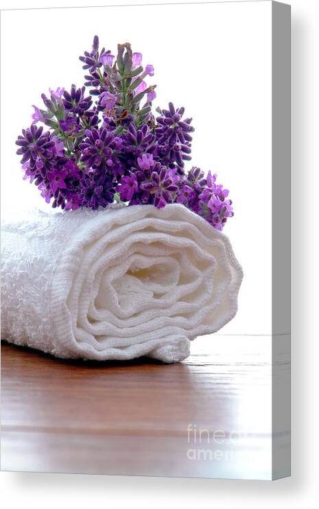 Aromatherapy Canvas Print featuring the photograph Lavender Flowers on a White Bath Towel in a Spa by Olivier Le Queinec
