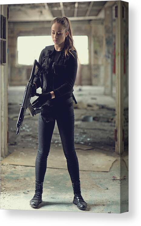 Expertise Canvas Print featuring the photograph Female military swat team member holding rifle in abandoned warehouse #3 by Lorado