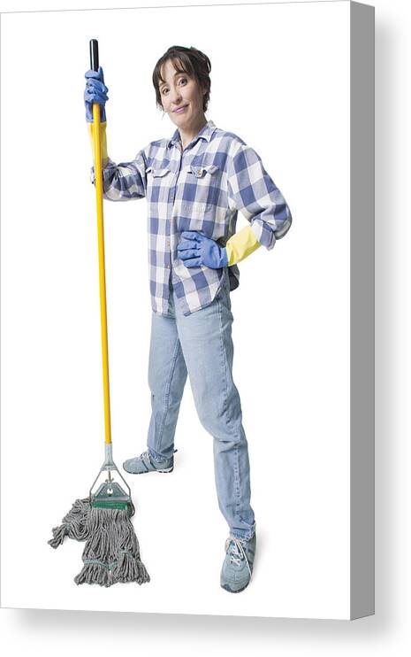 Working Canvas Print featuring the photograph A Caucasian Woman In Jeans And A Plaid Shirt Wears Rubber Gloves And Holds A Mop by Photodisc