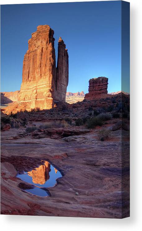 Courthouse Towers Canvas Print featuring the photograph Courthouse Towers and pool reflection Park Avenue at Arches National Park by Peter Herman
