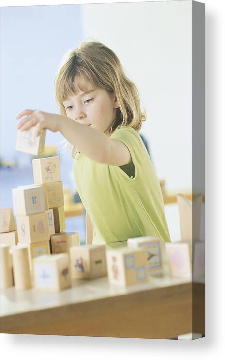 White People Canvas Print featuring the photograph Girl playing with blocks by Comstock