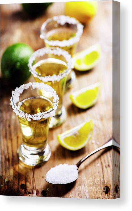 Tequila Canvas Print featuring the photograph Golden mexican tequila in shot glasses by Jelena Jovanovic