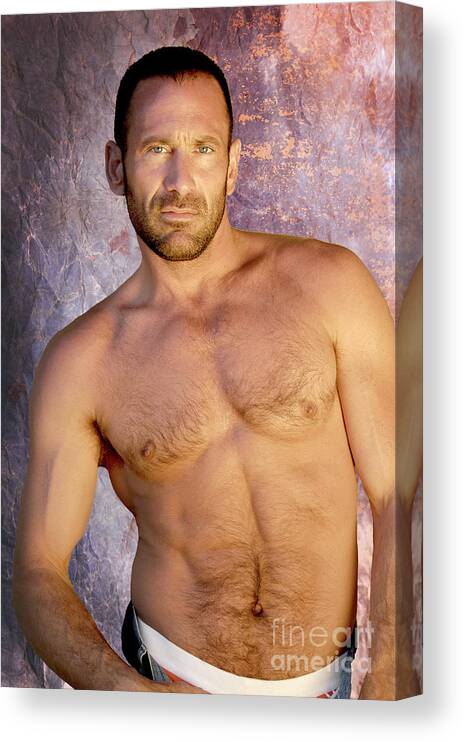 Homoerotic Canvas Print featuring the photograph Handsome and muscular man poses for a studio portrait showing that he is in great muscular body. by Gunther Allen
