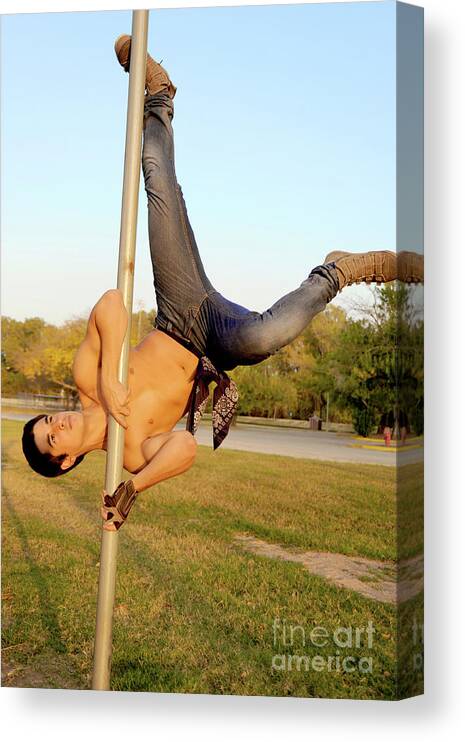 Handsome young hispanic man shows off some pole dance moves Canvas