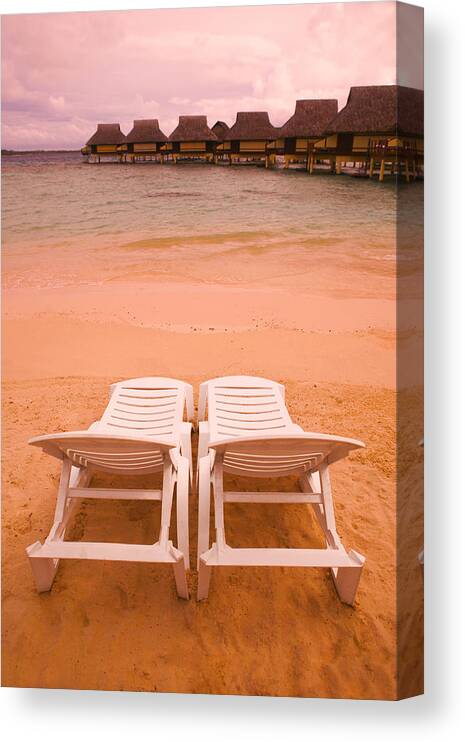 Water's Edge Canvas Print featuring the photograph Landscape Photograph Of Two Empty Beach Chairs Overlooking A Beautiful Beach And Resort by Photodisc