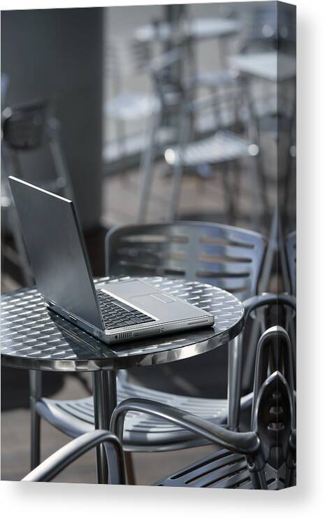 Computer Canvas Print featuring the photograph Laptop at a cafe by Comstock Images