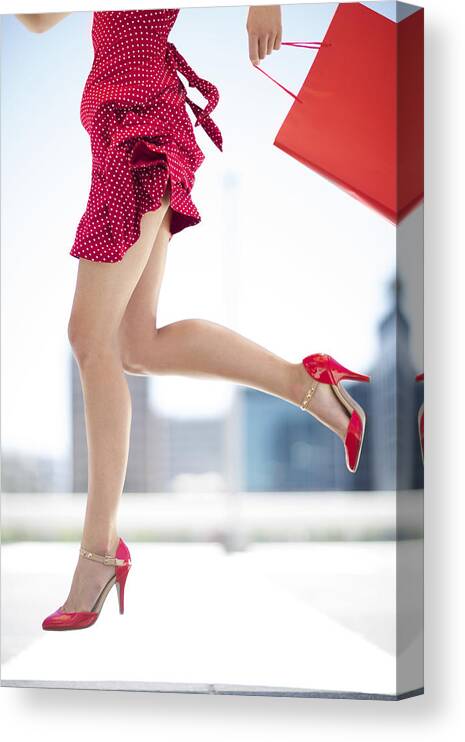 People Canvas Print featuring the photograph Legs of red dressed woman with shopping bag by Westend61